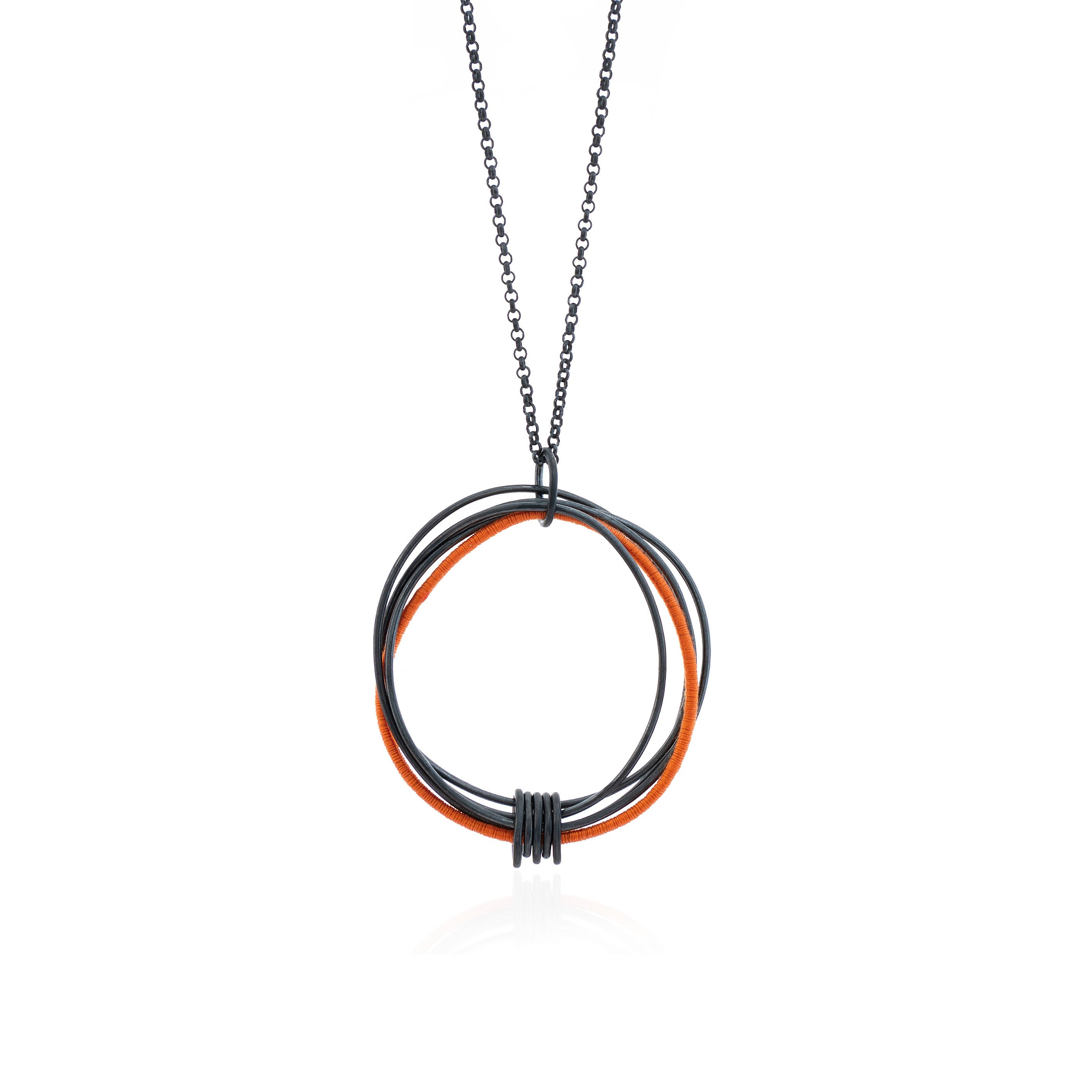 Wrapped Orange Oxidized Pendant on Chain (large) features five large oxidized wire circles of varying sizes that are linked together with five small oval links attached to the base of the pendant, with one large wire circle wrapped with orange cotton thread and suspended on an oxidized belcher style chain, handmade in Adelaide, South Australia by Melissa Gillespie Jewellery