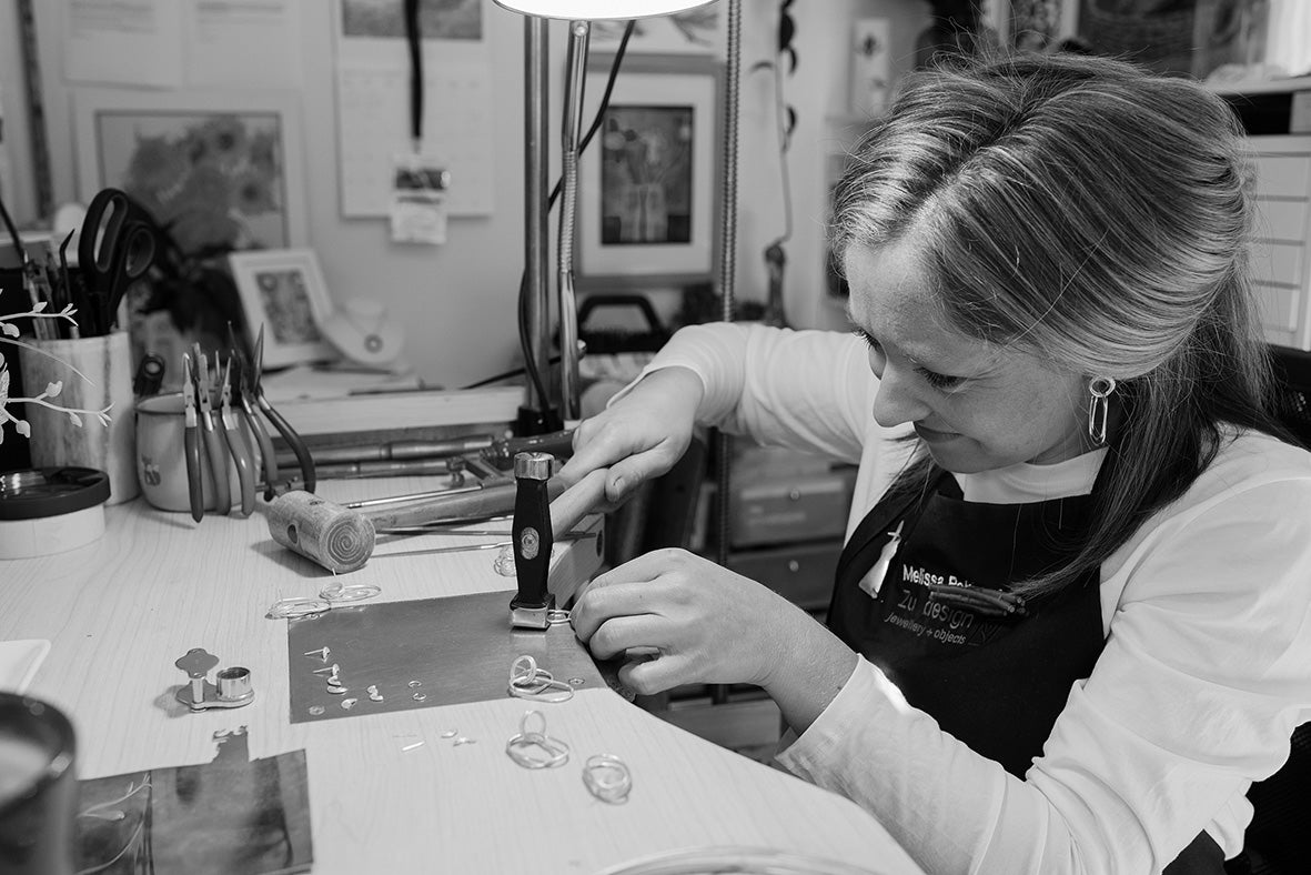 Melissa Gillespie hammering at her jewellery bench creating unique Contemporary Jewellery handmade from Sterling Silver in Adelaide, South Australia