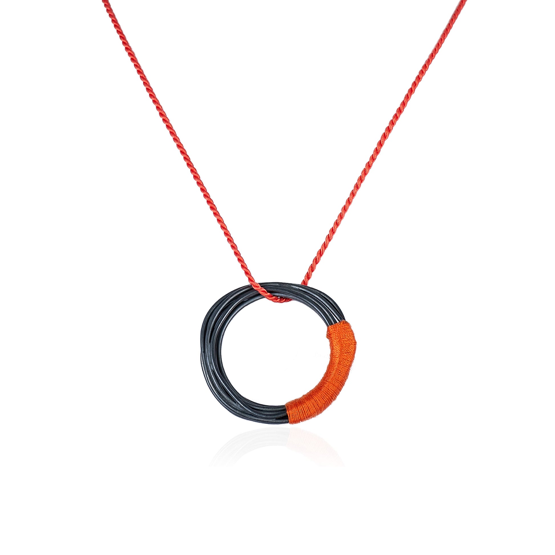 Circular oxidized sterling silver pendant with orange silk cord, handmade in Adelaide, South Australia by Melissa Gillespie Jewellery