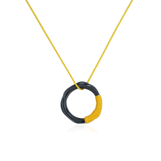 Circular oxidized sterling silver pendant with yellow silk cord, handmade in Adelaide, South Australia by Melissa Gillespie Jewellery