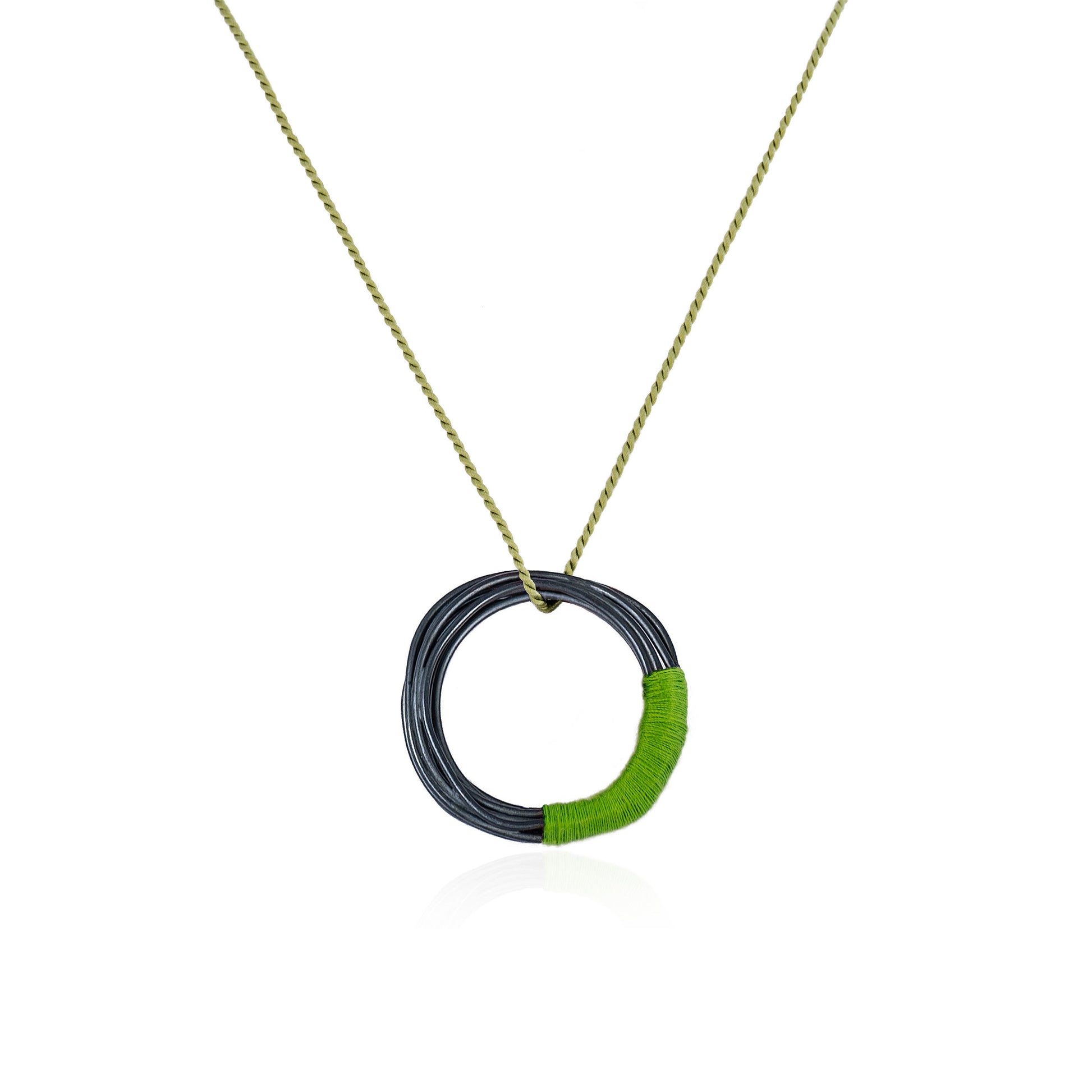 Circular oxidized sterling silver pendant with green silk cord, handmade in Adelaide, South Australia by Melissa Gillespie Jewellery