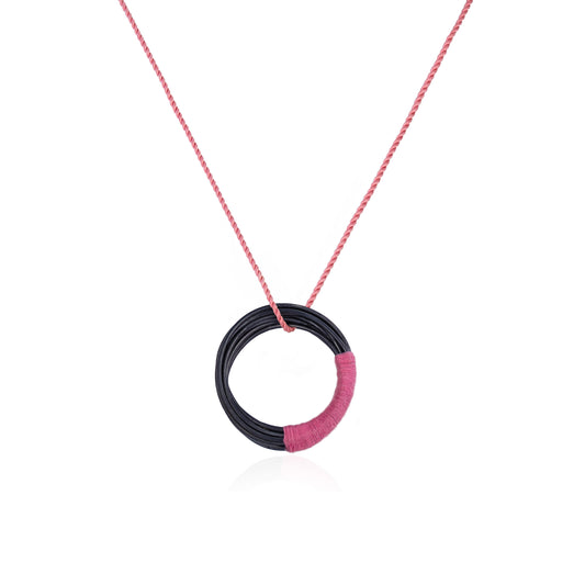 Circular oxidized sterling silver pendant with pink silk cord, handmade in Adelaide, South Australia by Melissa Gillespie Jewellery