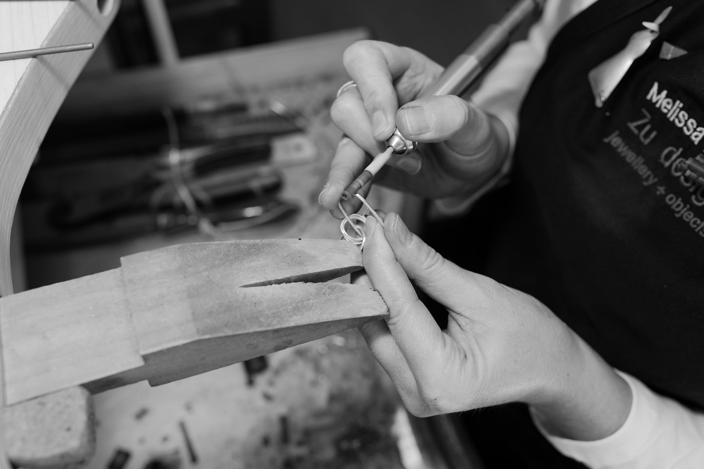 Melissa Gillespie at her jewellery bench shaping and cleaning a Sterling Silver earring from her studio in Adelaide, South Australia.