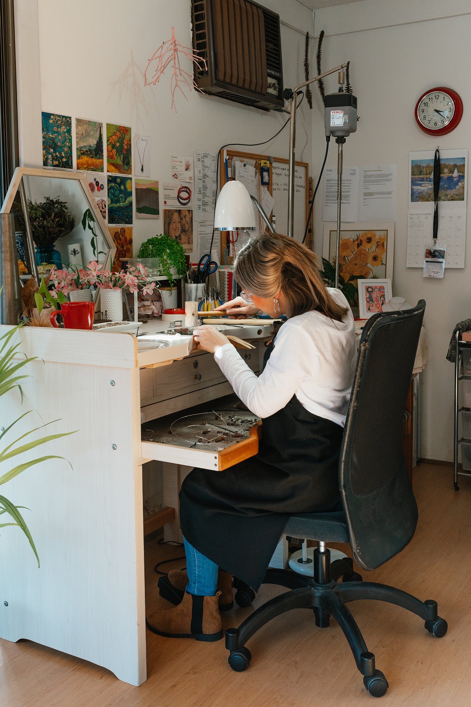 Melissa Gillespie seated at her jewellery bench inside her home-studio in Adelaide, South Australia working on some handmade Contemporary Jewellery pieces in Sterling Silver.