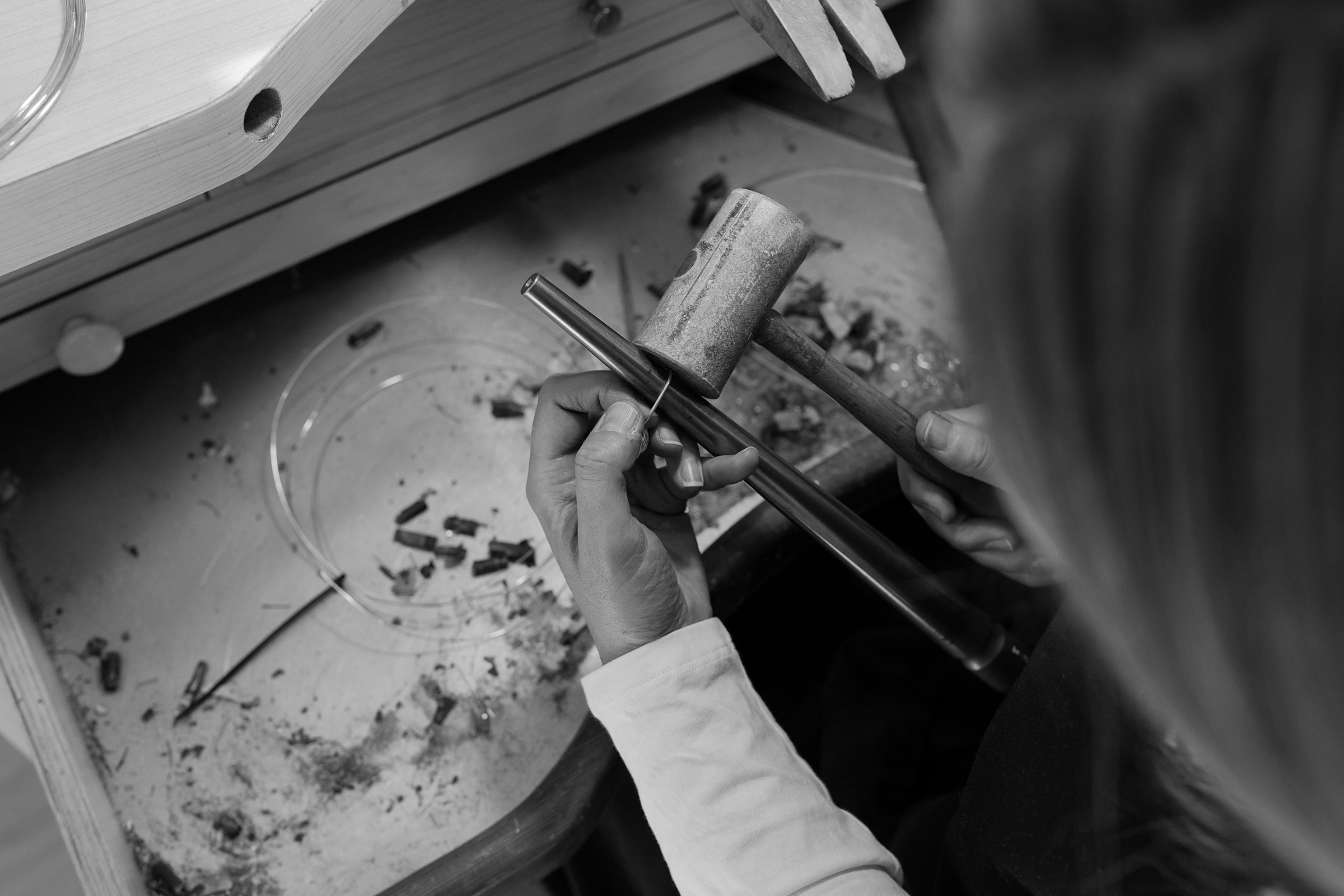 Melissa Gillespie hammering an earring at her jewellery bench creating unique Contemporary Jewellery handmade from Sterling Silver in Adelaide, South Australia